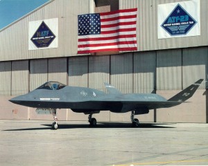 YF-23 outside hangar with flags